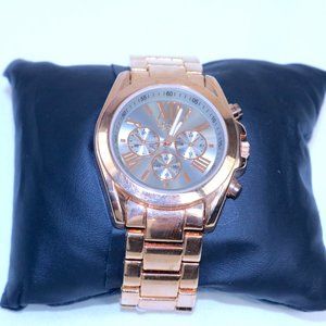 This is a new gold-toned stainless steel watch.